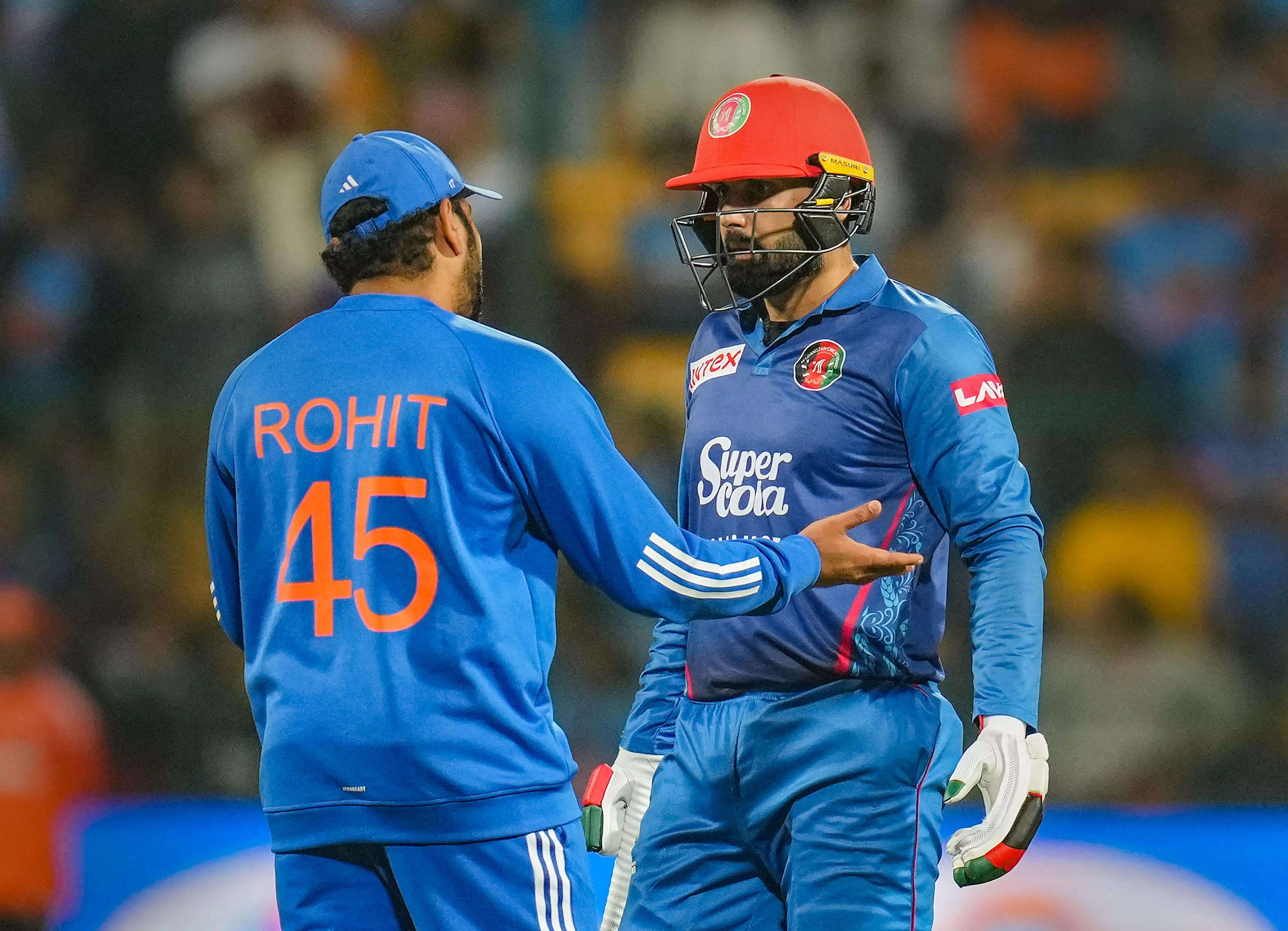 Rohit Sharma interacts with Afghanistan's Mohammad Nabi during the third T20 cricket match between India and Afghanistan, at M Chinnaswamy Stadium, in Bengaluru. (PTI Photo)