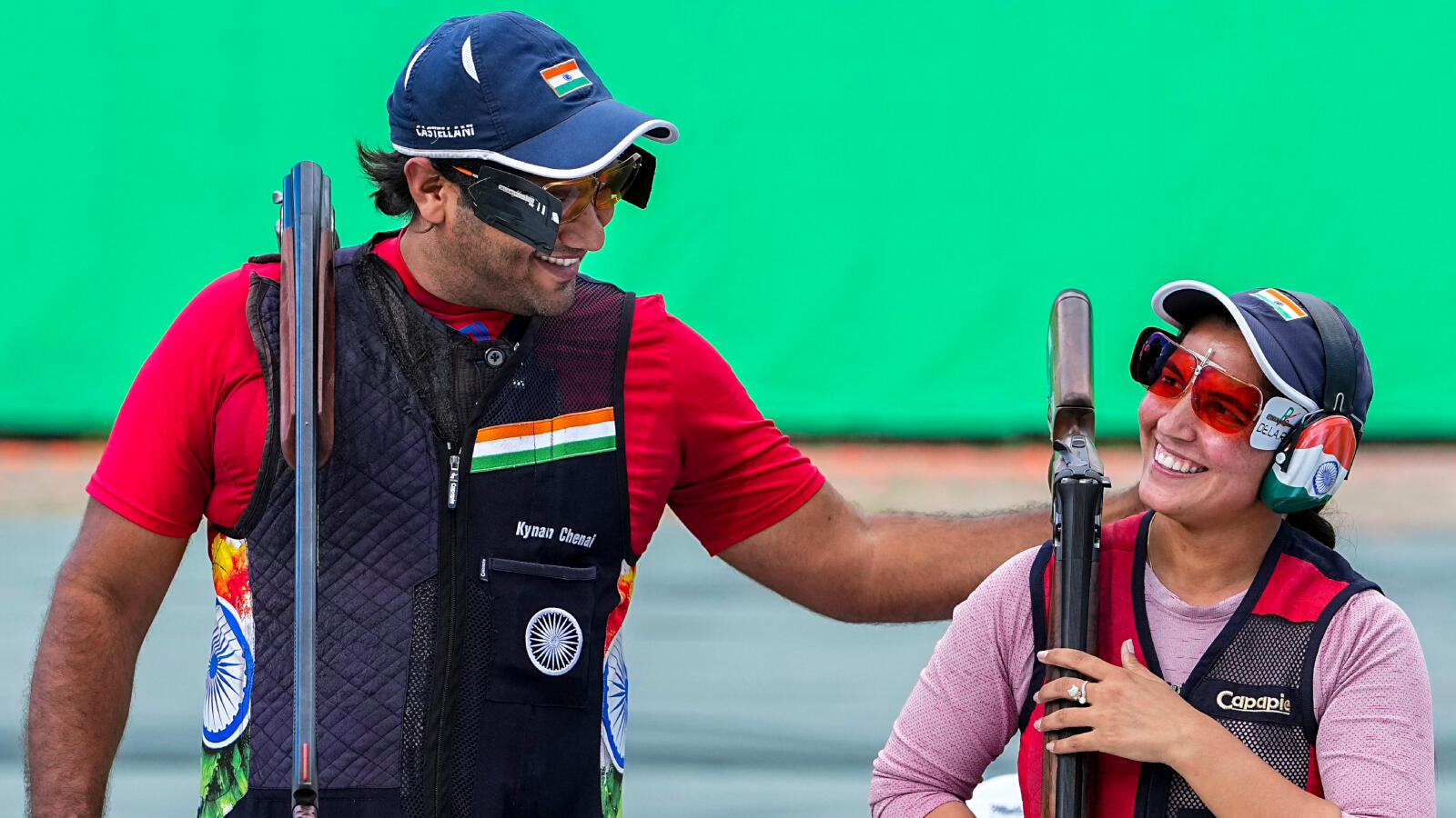 India's Neeru Dhanda, left, and Kynan Chenai celebrate after winning gold medal