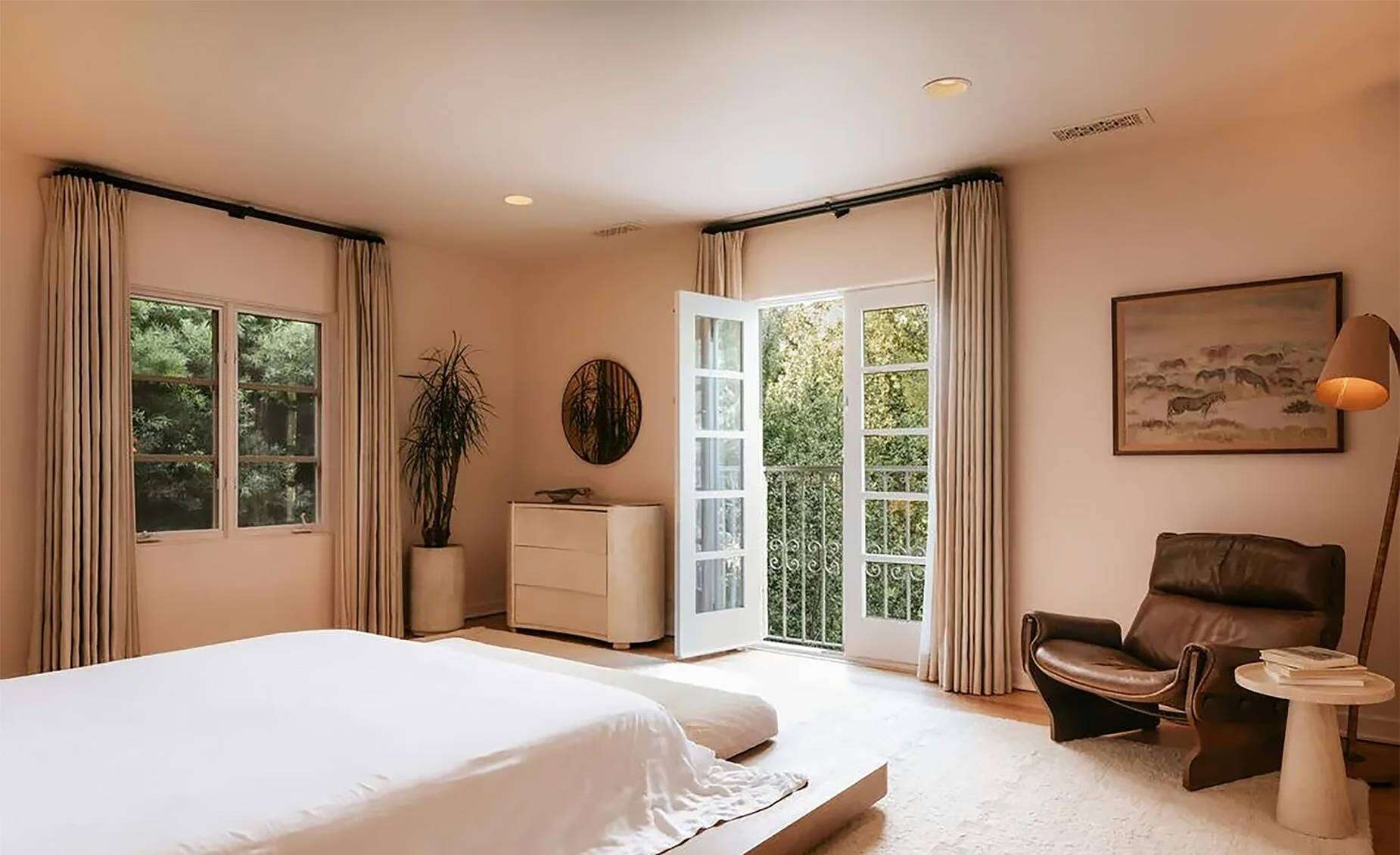 Custom stone and wood accents feature in the bathrooms, while a bedroom opens onto a sunroom and private balcony.
