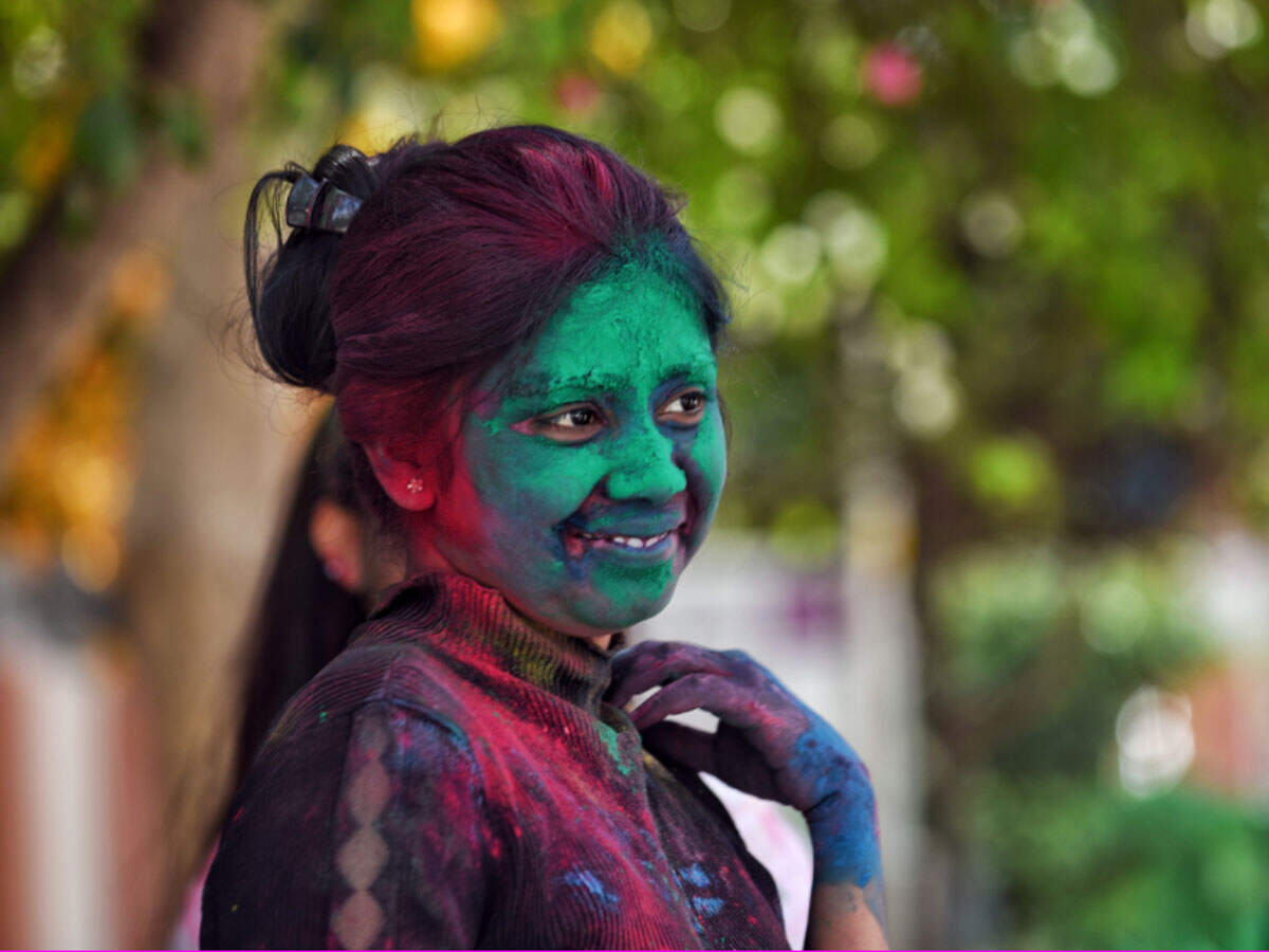 A YMCA student celebrates Holi at Patel Chowk metro station in New Delhi on Saturday. ANI