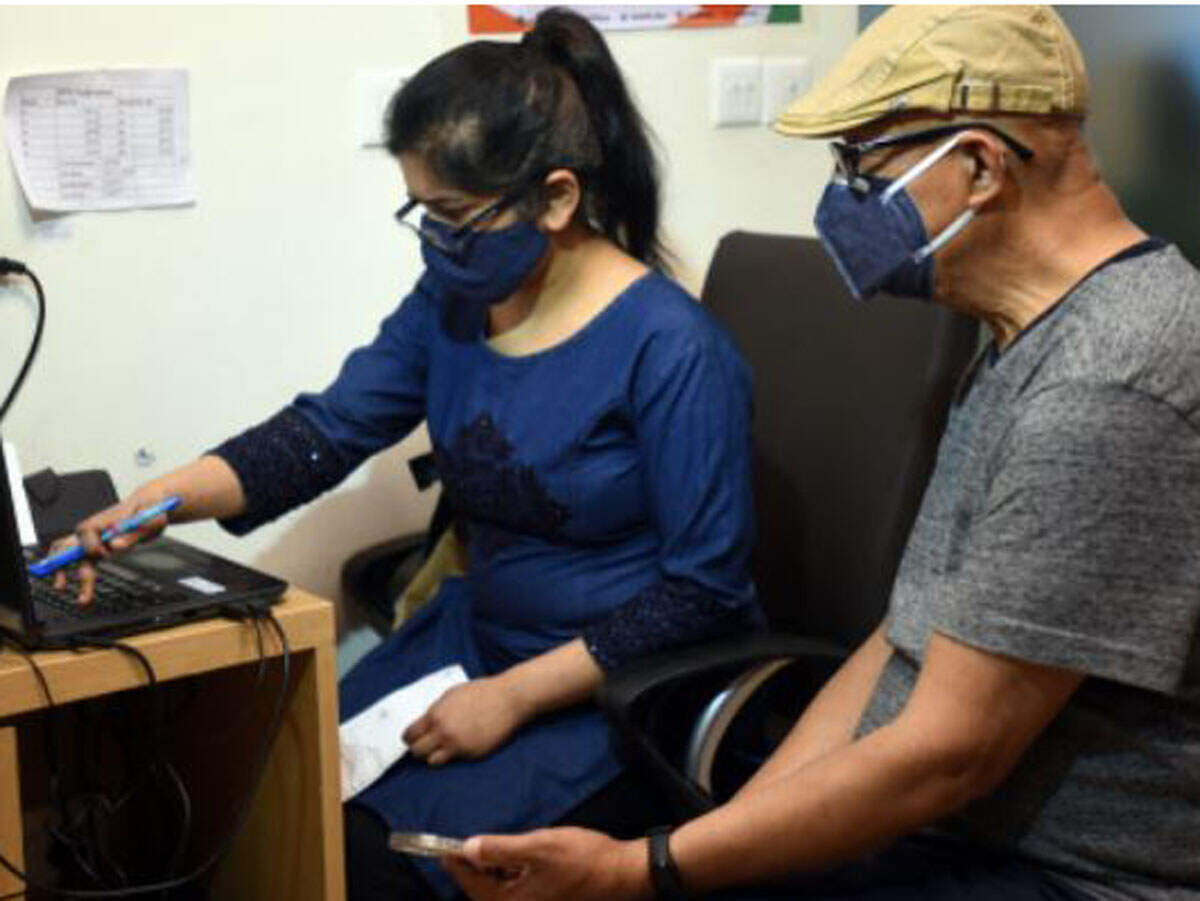 FILE: An old man waits for OTP on his mobile to receives a Covid-19 coronavirus vaccine at Max Hospital in New Delhi on March 1. TOI Photo: Piyal Bhattacharjee