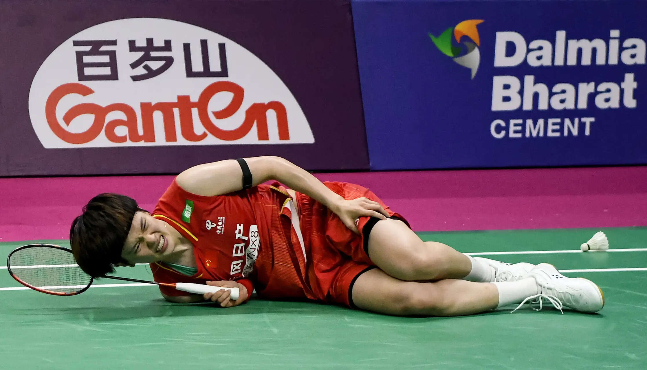 New Delhi, Aug 20 (ANI): China's Wang Zhi Yi falls on the court during the women...