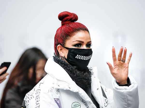A woman wears a face mask during the London Fashion Week