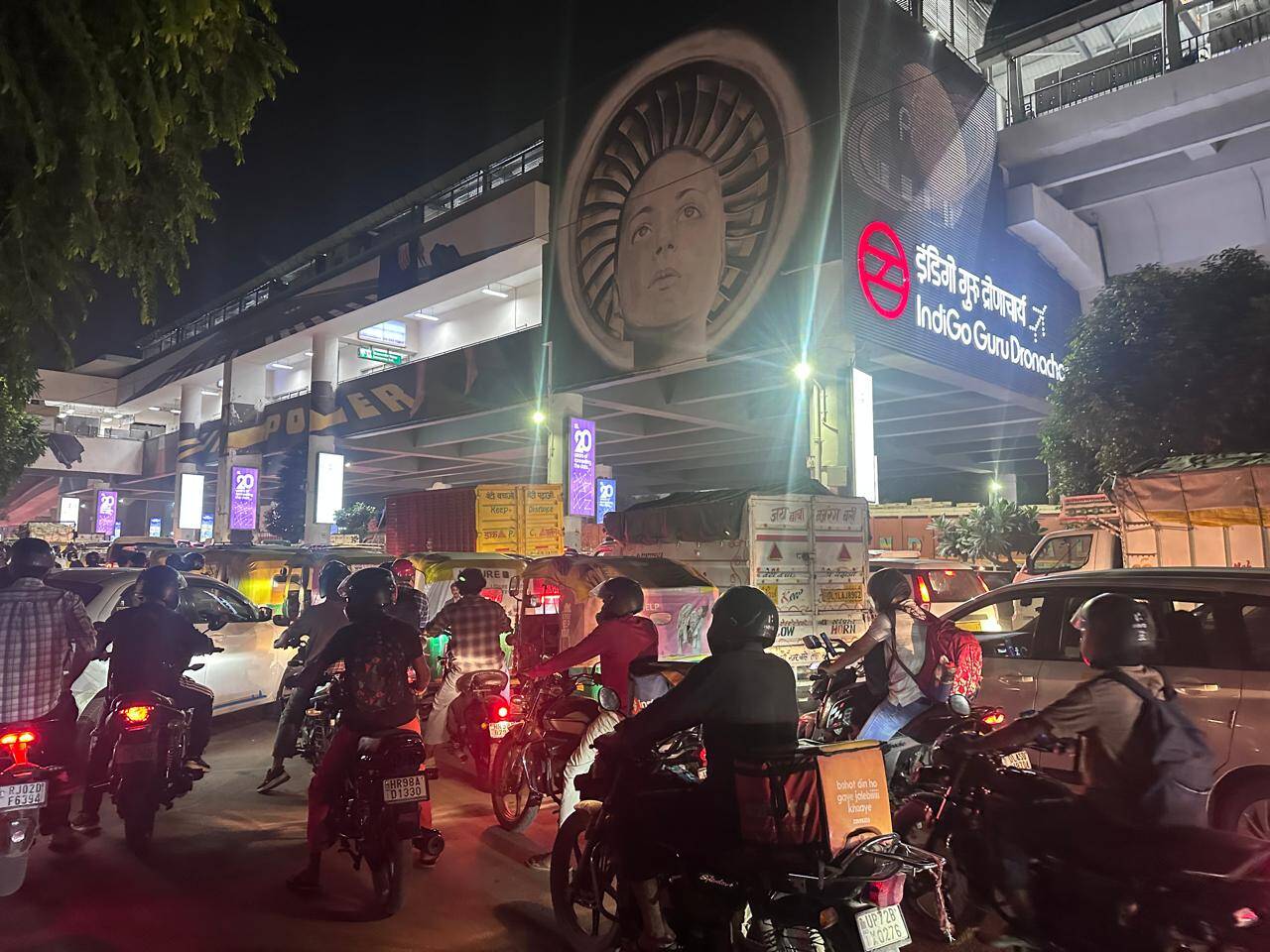 Two-wheeler riders seen squeezing through narrow gaps between cars