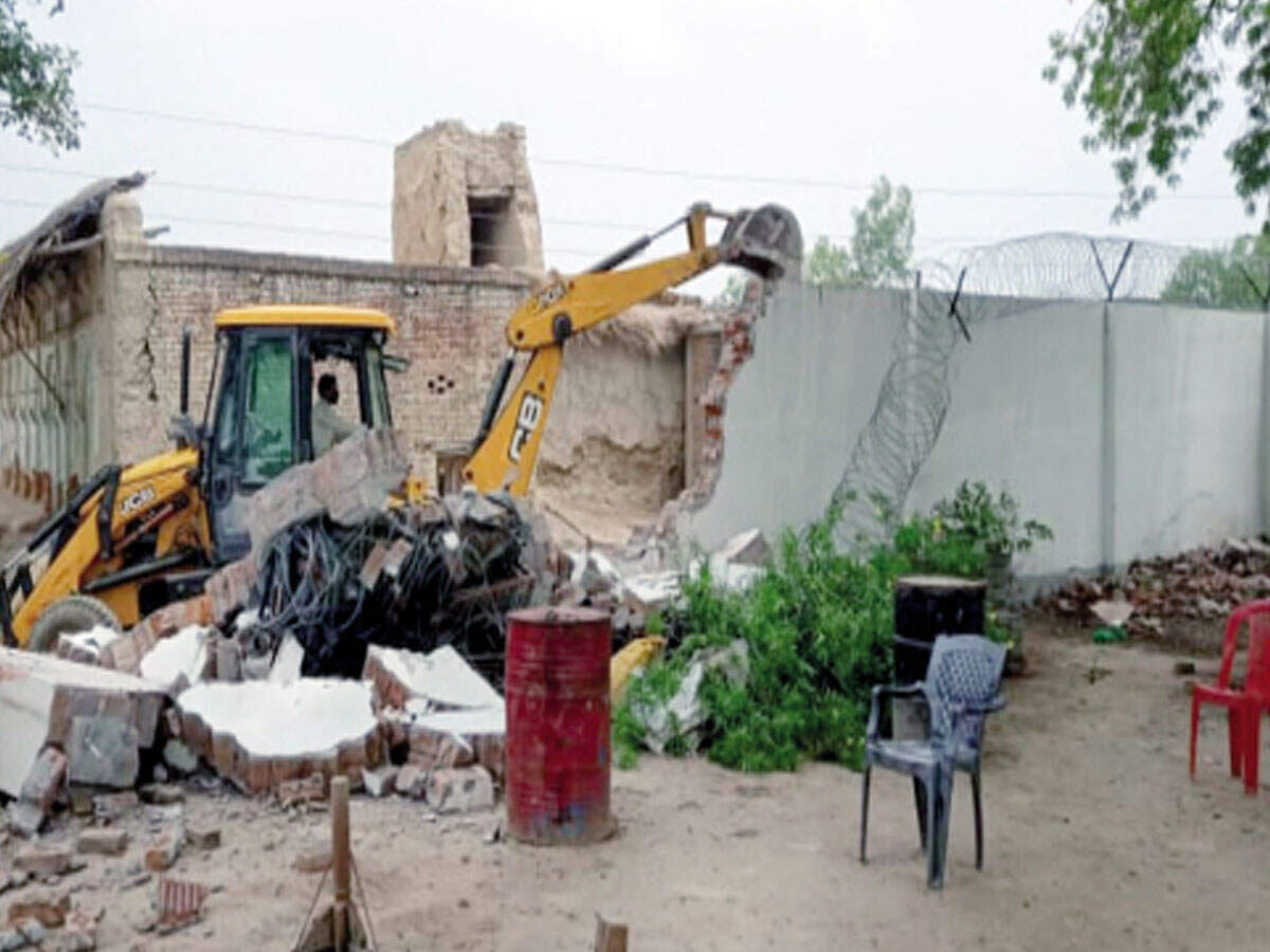 Bulldozer pulling down boundary walls of gangster Vikas Dubey’s house