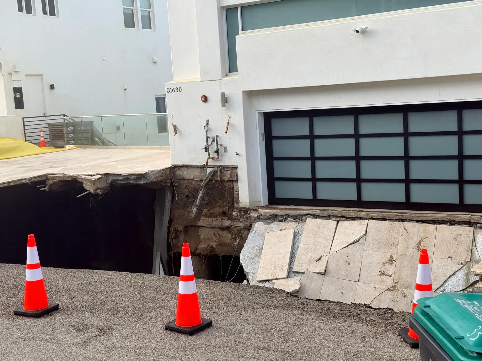 A 30ft-wide crater appeared outside the 4,000-square-foot property amid coastal erosion.