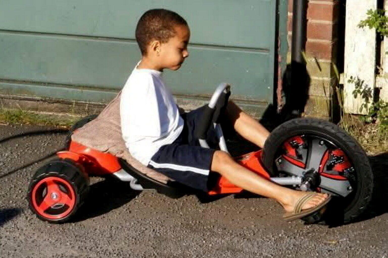 Nine-year-old Callum Smith cycles using his feet.