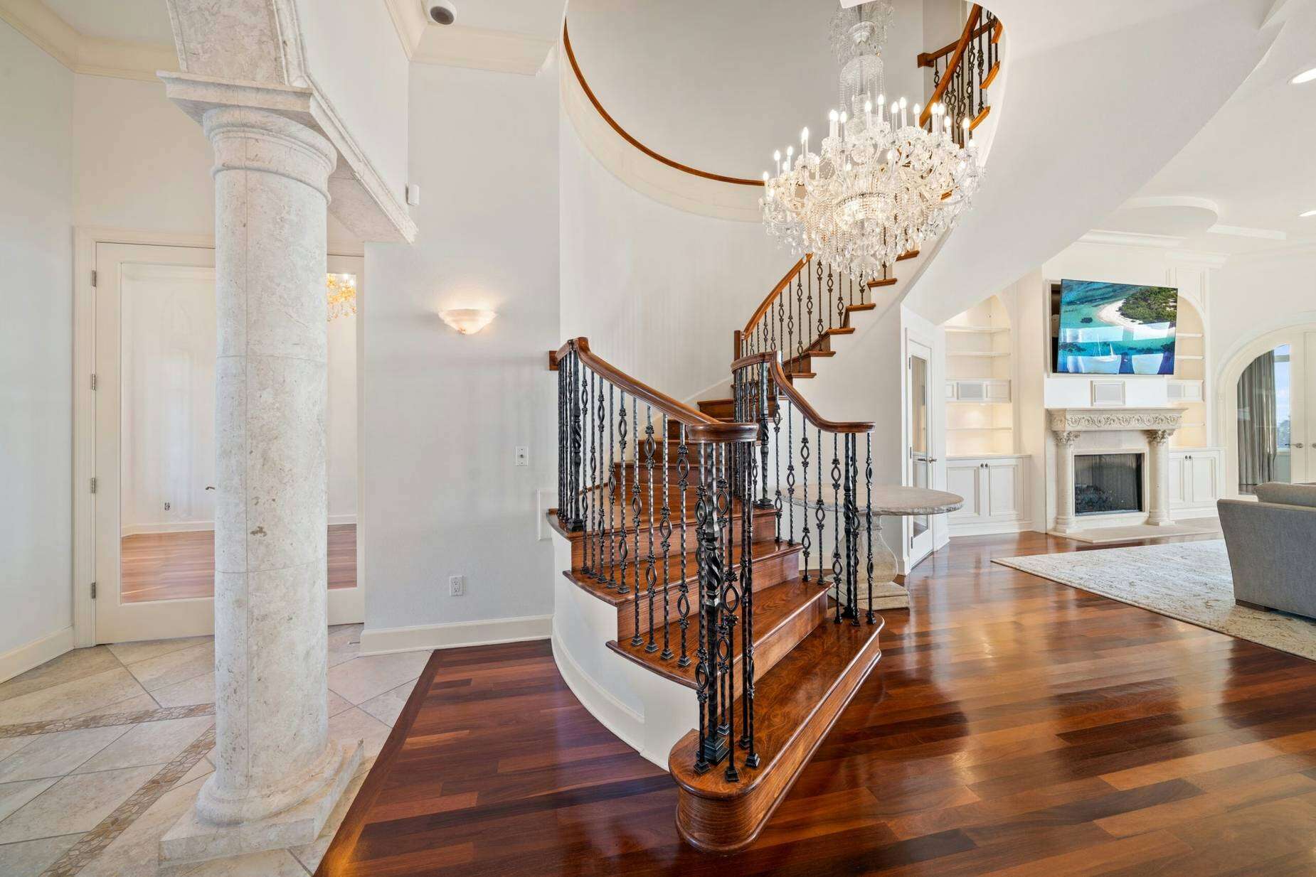The five-bedroom mansion features teak, marble and natural stone floors, plus a gas fireplace.
