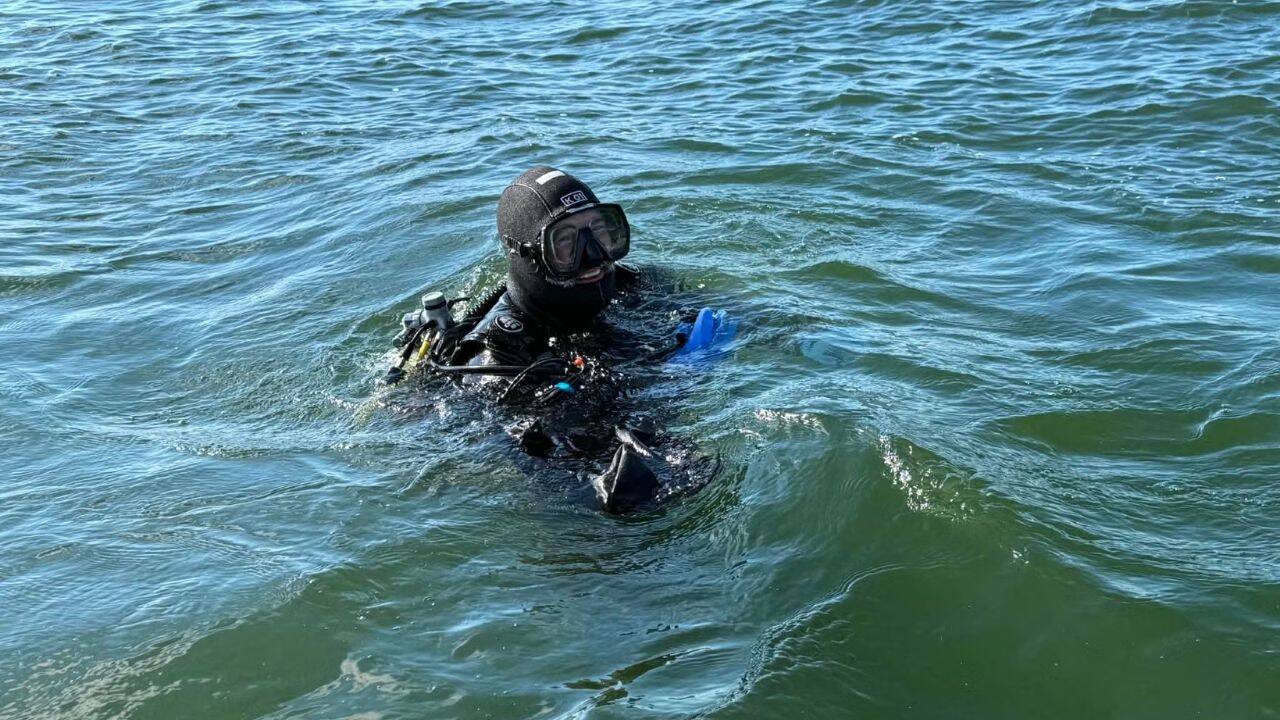 Mark Schachtner, a diver from Beaver Dam, spotted a partially buried 17-foot dugout canoe while exploring Pewaukee Lake in May<br>