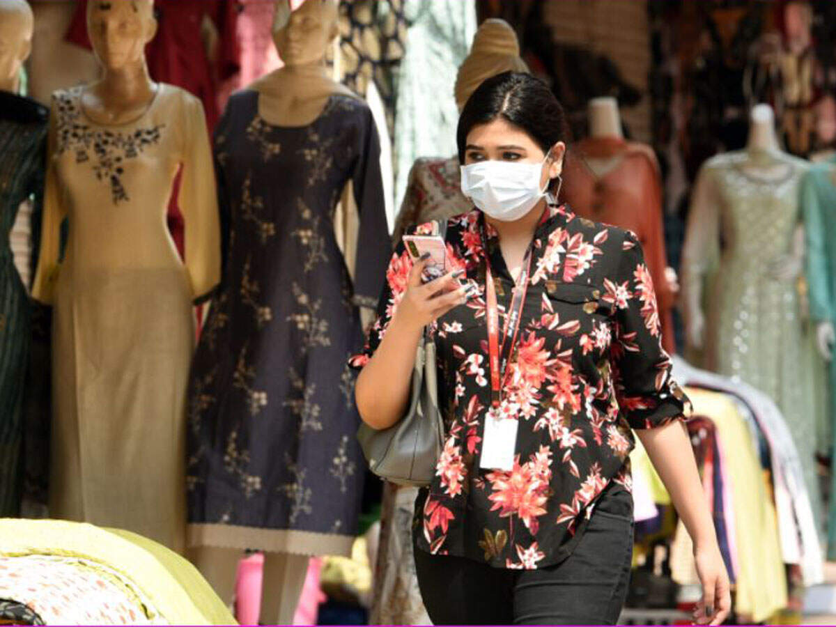 A woman walks past an open shop at Lajpat Nagar Central Market after further ease in the Covid-19 lockdown, in New Delhi, Monday. TOI Photo: Piyal Bhattacharjee