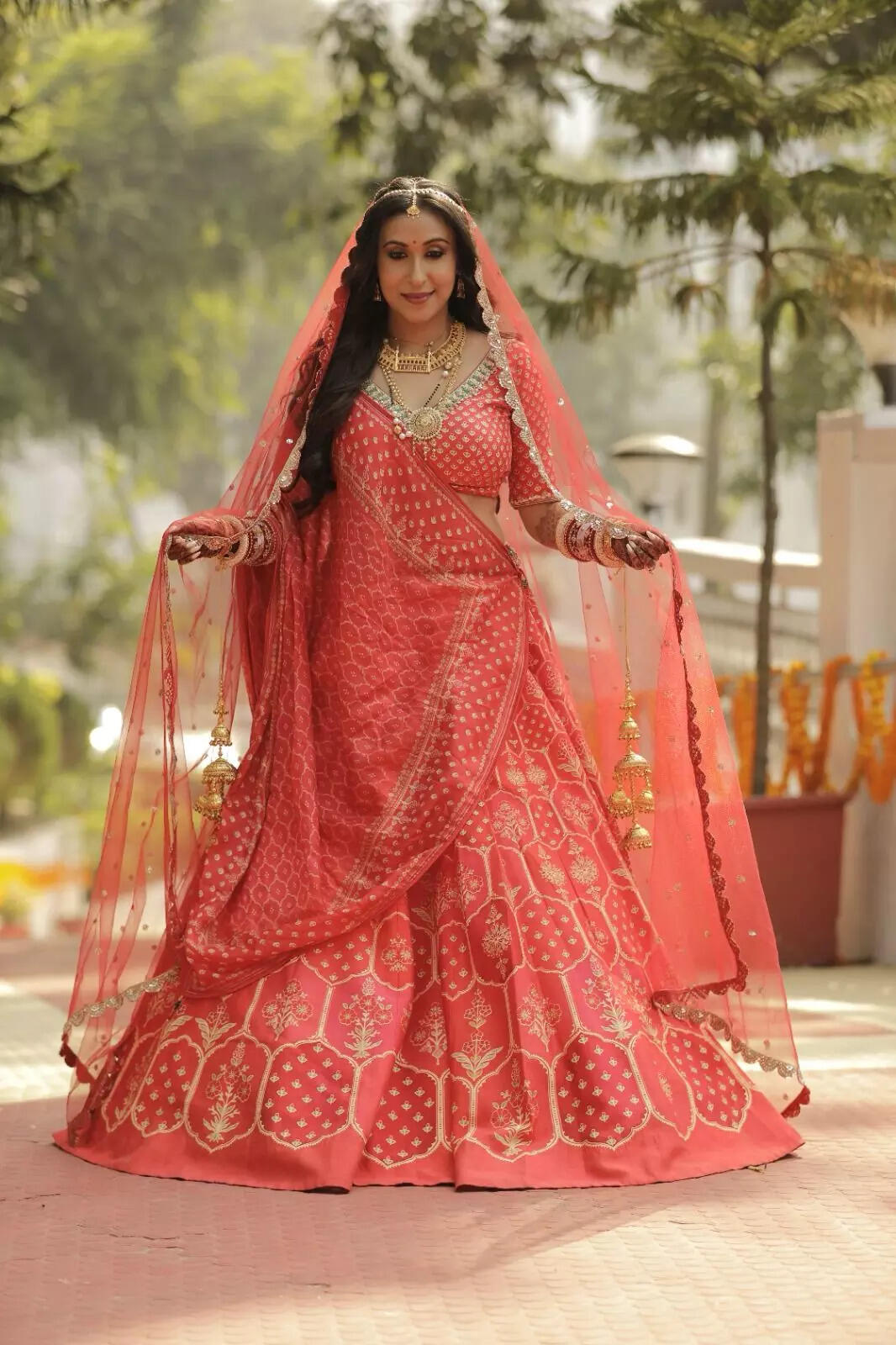 Sayani Datta falunting her necklace.