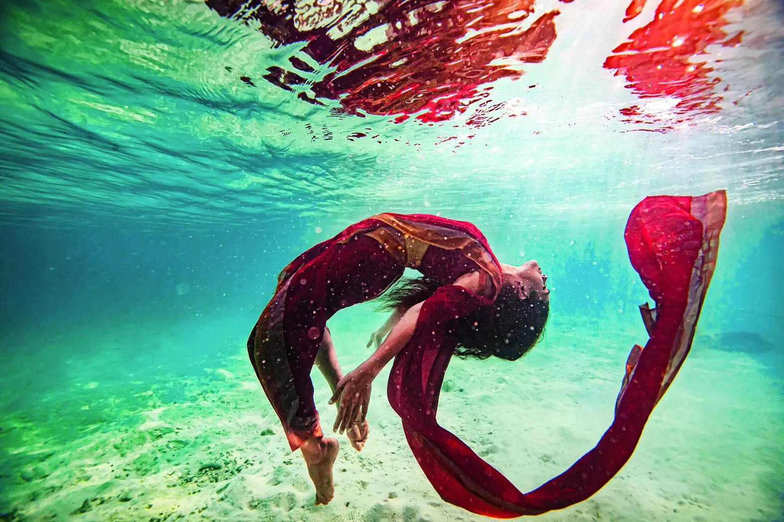 THROWBACK: A pic from the 2020 shoot of Rukmini swimming in the ocean in a sari that eventually began her adventure with diving