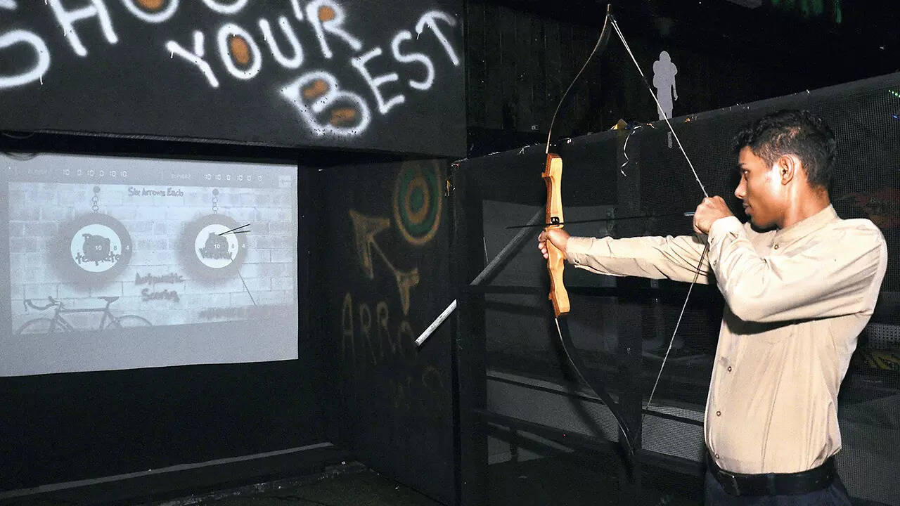 A young boy testing his archery skills at a gaming zone in Kanpur