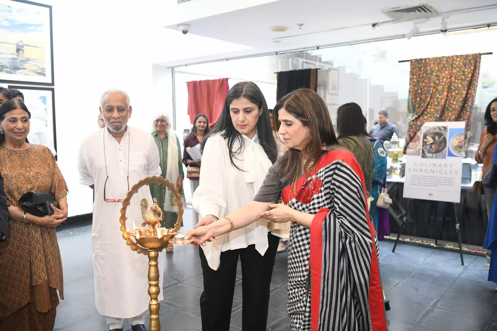 Photographer Megha Sindwani lights the lamp with Bhavna Minocha
