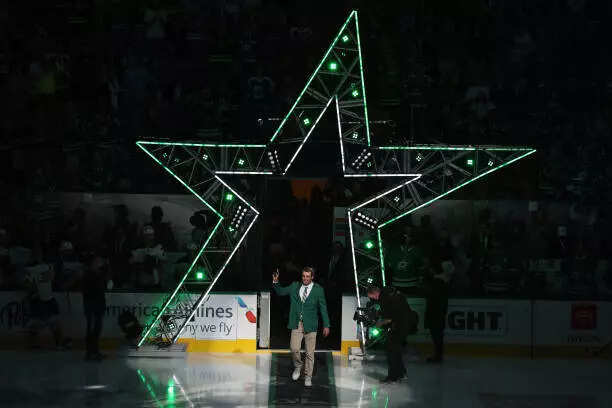 Scottie Scheffler walks onto the the ice for the ceremonial puck drop
