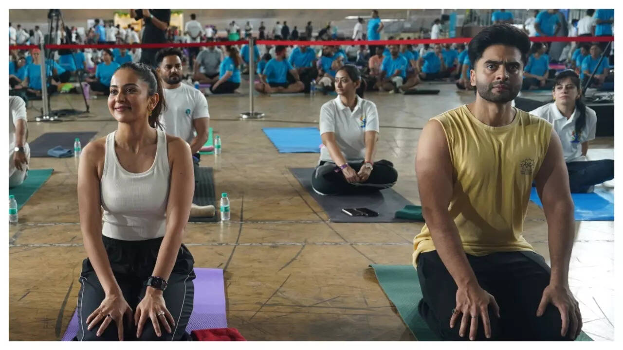 Jackky Bhagnani and Rakul Preet Singh join participants in performing Surya Namaskars at the World Yoga Day event at Indira Gandhi Stadium