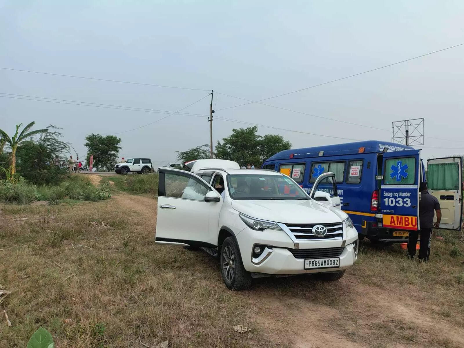 Fortuner SUV parked by the roadside near fields.