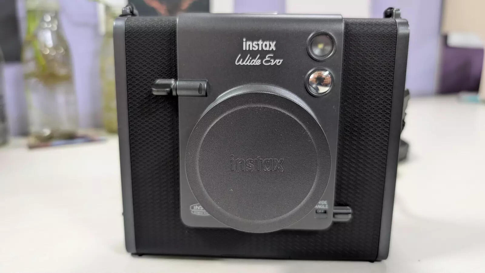 Cover protecting the lens of Instax Wide Evo