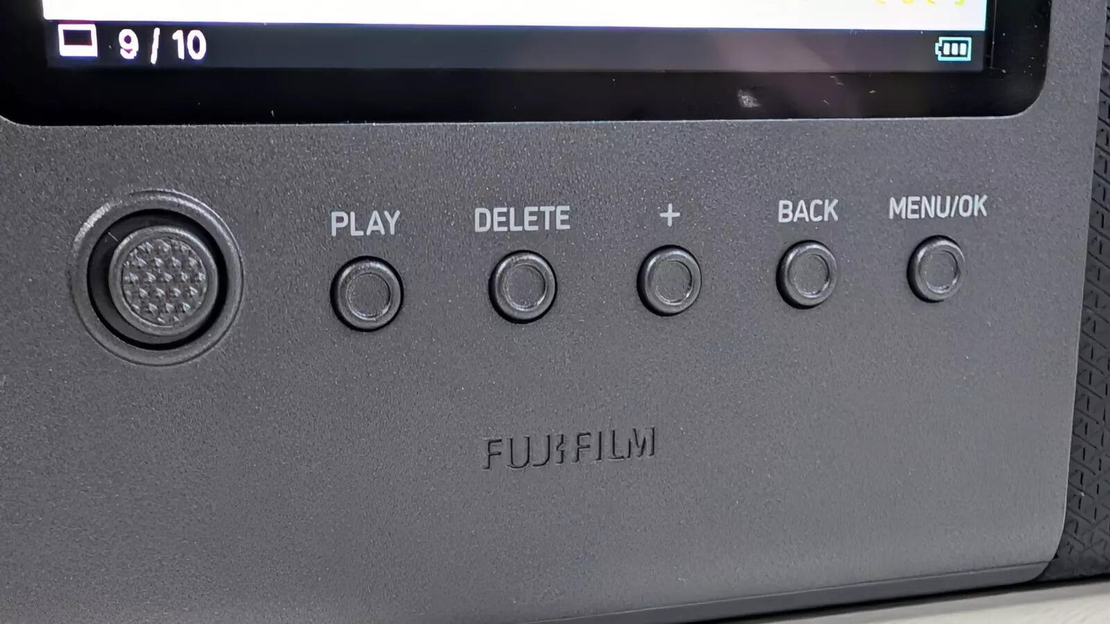 Control buttons are placed below the display