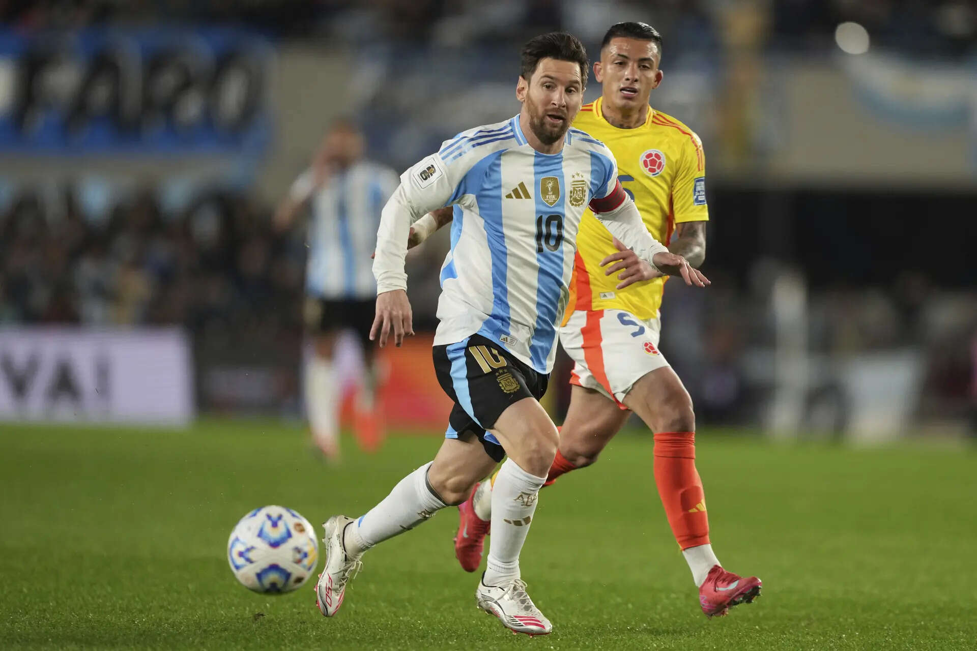 Argentina's Lionel Messi, front, and Colombia's Kevin Castano run for the ball during a qualifying soccer match for the FIFA World Cup 2026 at the Monumental stadium in Buenos Aires, Argentina, Tuesday, June 10, 2025. (AP Photo/Natacha Pisarenko) Argentina Colombia Wcup Soccer