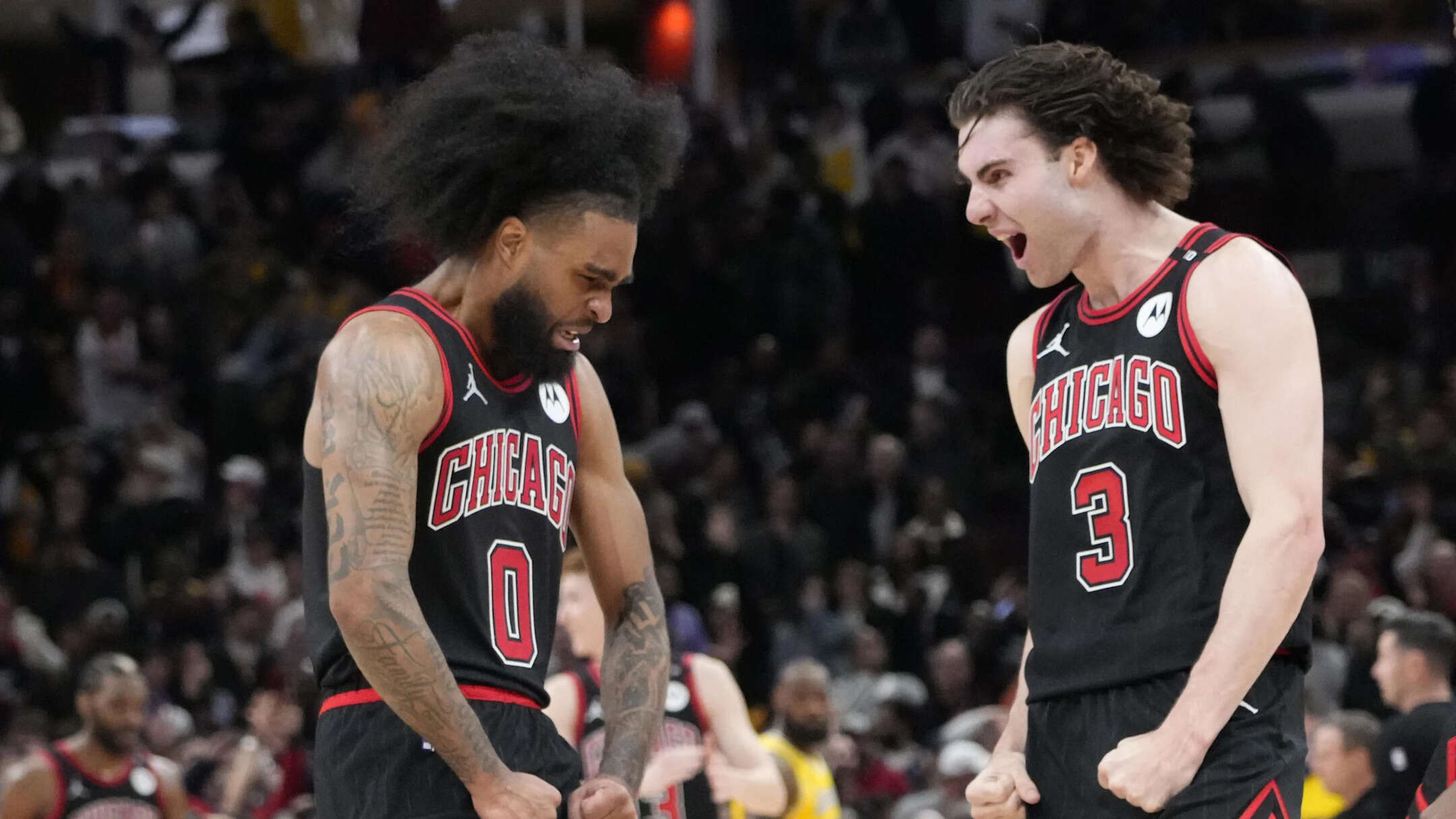 Chicago Bulls guard Coby White (0) celebrates his three point basket against the Los Angeles Lakers with guard Josh Giddey (3) during the second half at United Center