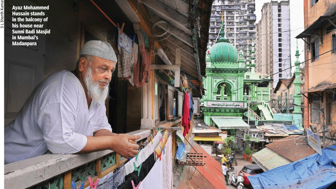 Ayaz Mohammed Hussain stands in the balcony of his house near Sunni Badi Masjid in Mumbai’s Madanpura