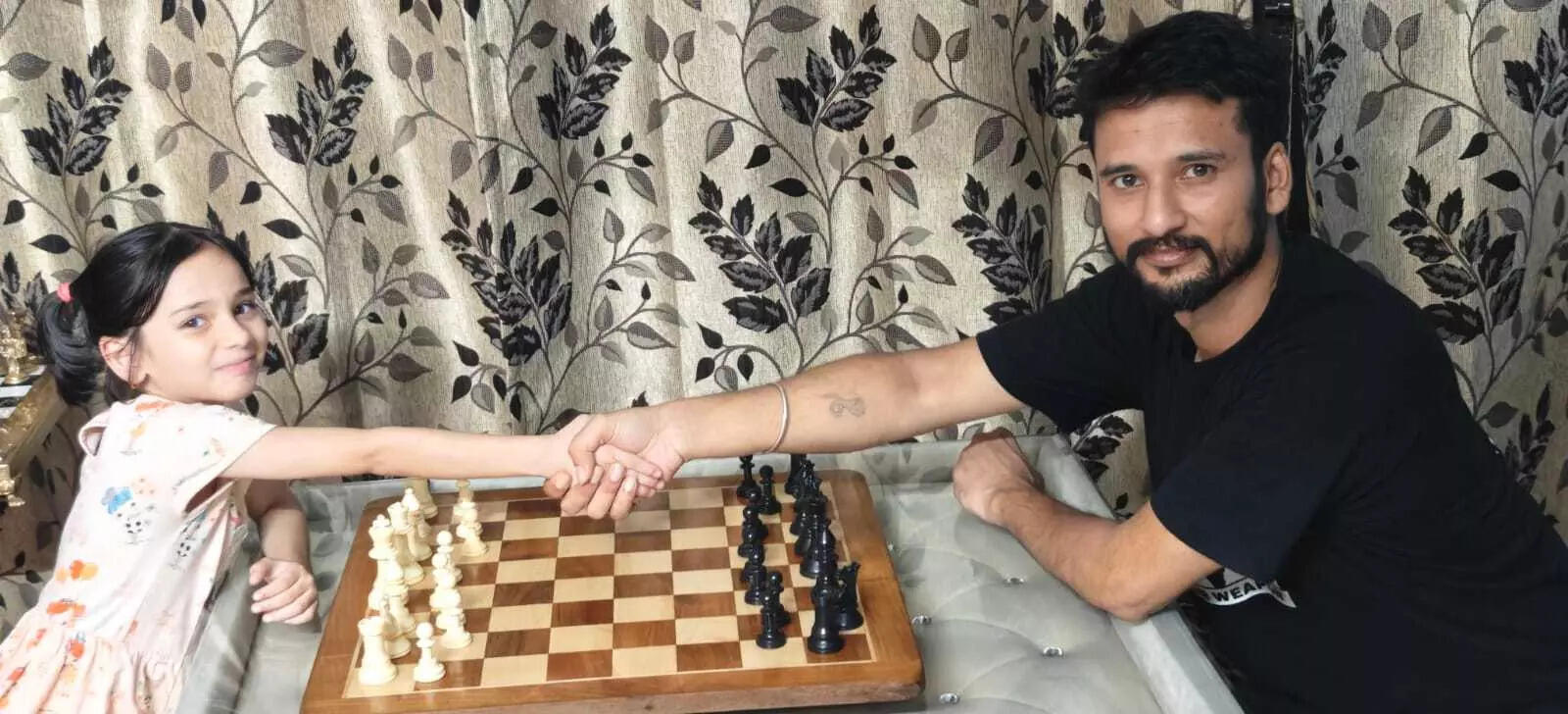 Aarini Lahoty plays chess with her father