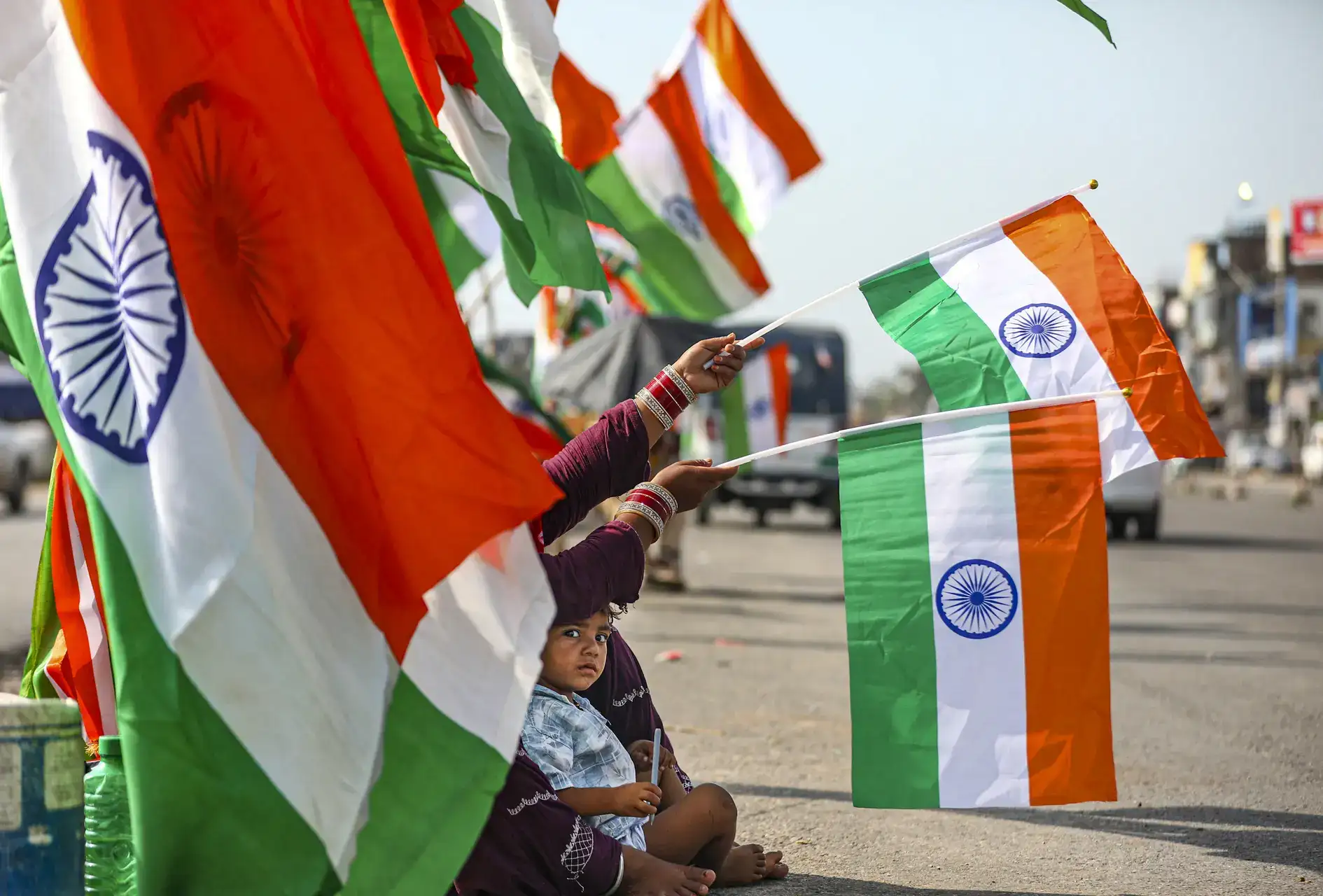 Jammu: A roadside vendor sells the national flags ahead of Independence Day, in Jammu. (PTI Photo)(PTI08_13_2025_000353A) Preps for Independence Day