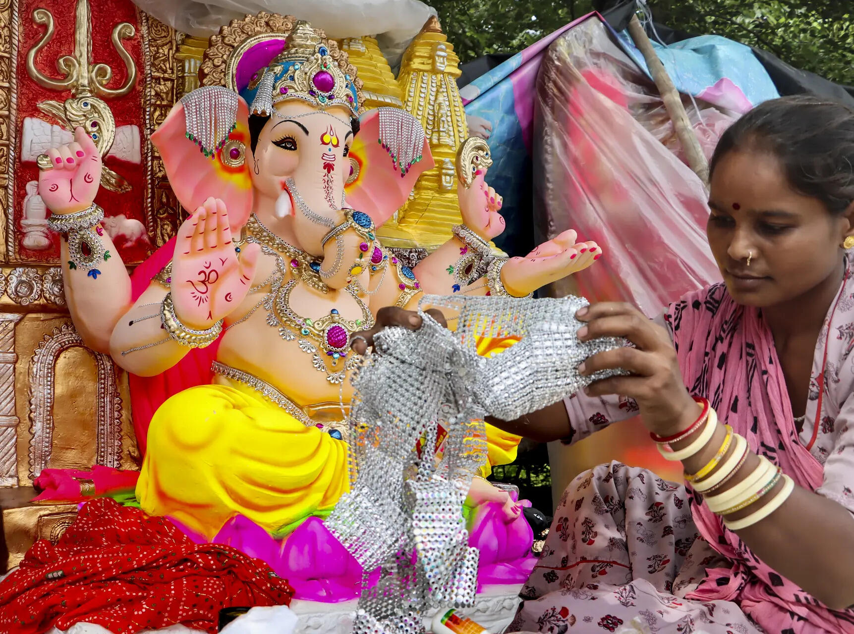 New Delhi: An artist decorates an idol of Lord Ganesha ahead of Ganesh Chaturthi festival, in New Delhi. (PTI Photo)(PTI08_13_2025_000314B) Ganesh Chaturthi preparations