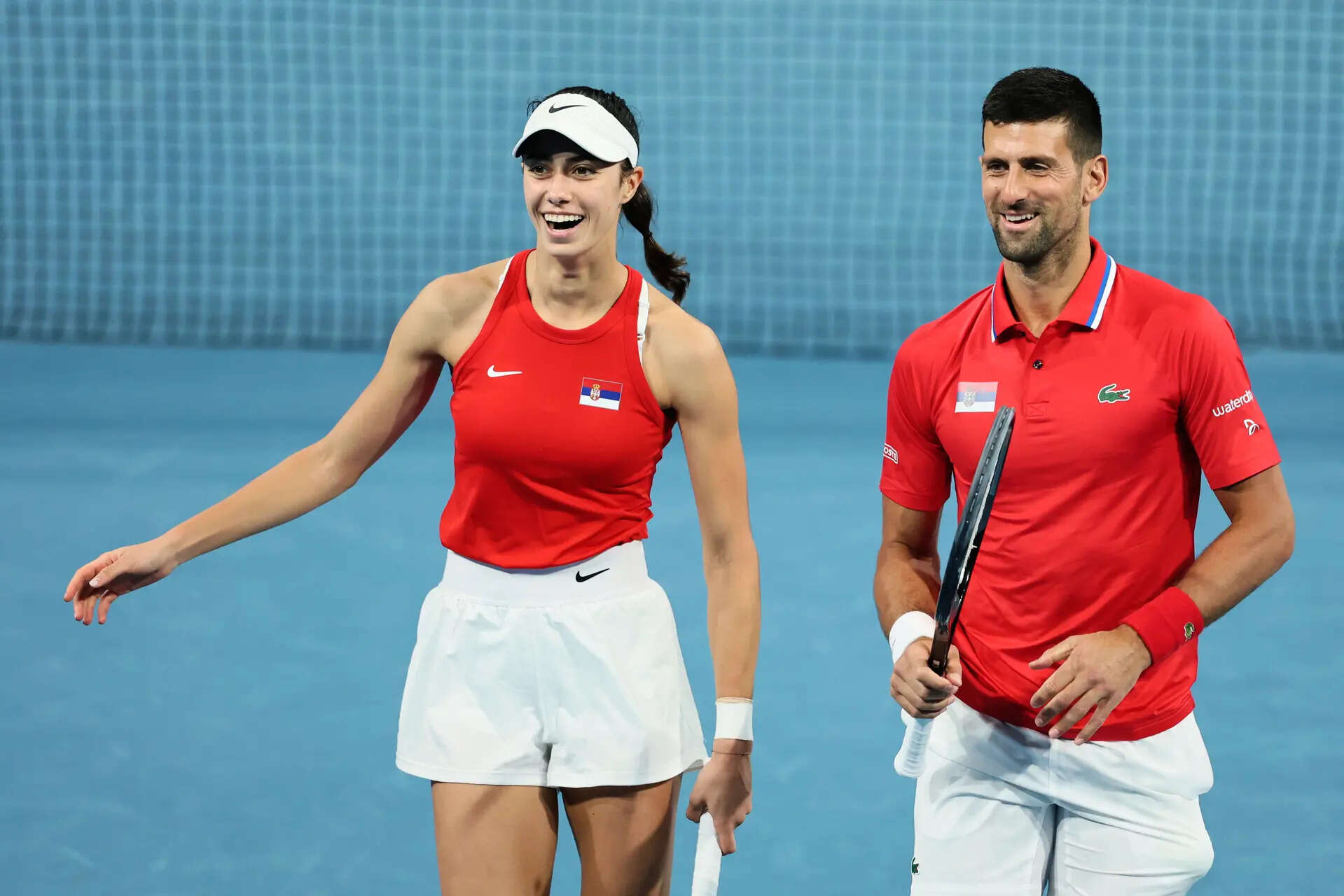 FILE - Novak Djokovic and Olga Danilovic of Serbia laugh on court during their mixed doubles match against Qinwen Zheng and Zhizhen Zhang of China during the United Cup tennis tournament in Perth, Australia, Sunday, Dec. 31, 2023. (AP Photo/Trevor Collens) There's a $1 million prize and big names for 2025 US Open mixed doubles. Why are some people upset?