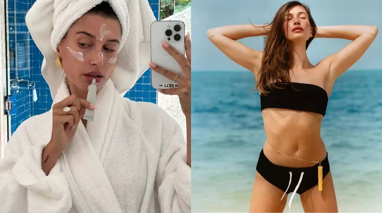 Hailey Bieber applying lip balm and wearing a belly chain to hold her lip tint