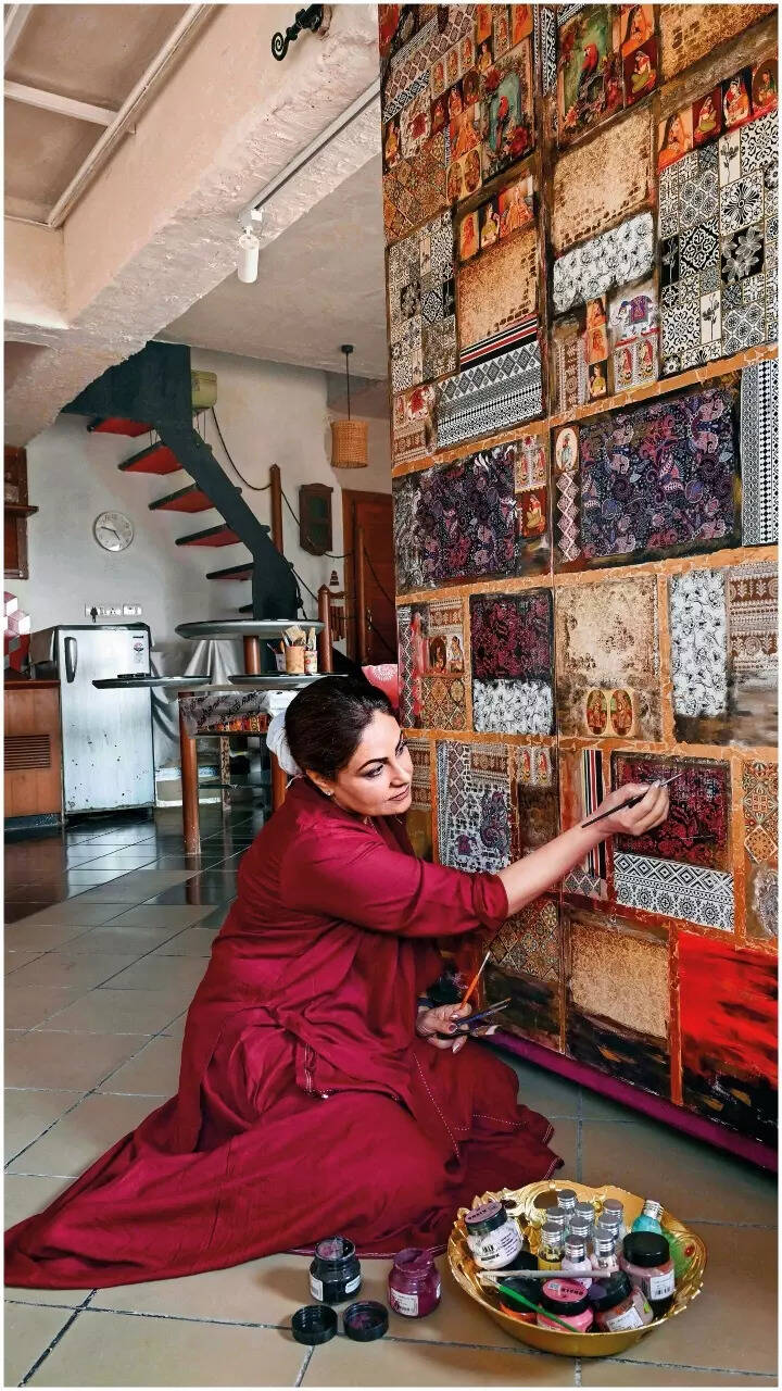 Ayesha Jhulka paints the wall of her house