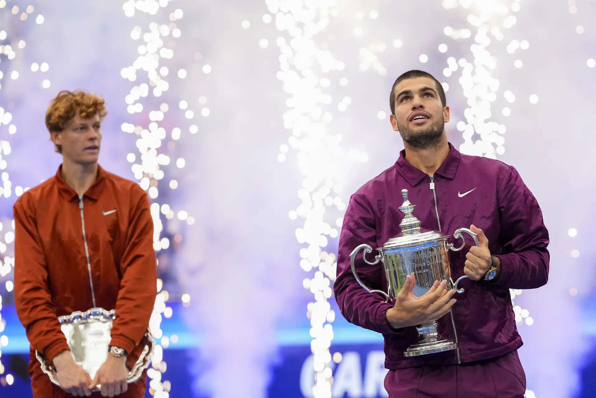 Carlos Alcaraz, of Spain, holds the championship trophy as Jannik Sinner, of Italy, looks on after Alcaraz defeated Sinner in the men's singles final of the U.S. Open tennis championships, Sunday, Sept. 7, 2025, in New York. (AP Photo/Kirsty Wigglesworth) Photo highlights from the US Open as Carlos Alcaraz overpowers Jannik Sinner