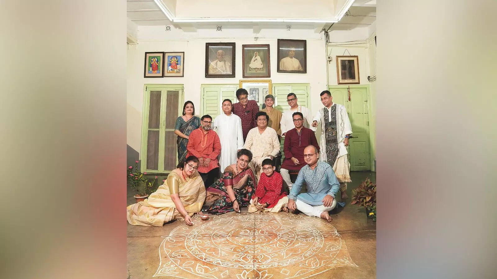 (Seated in the centre) Dhiman Das with his family friends (seated in front) Chandreyee Bhattacharyya, Paromita Guha Roy, Aryaraj Gupta and Indrajit Sinha drawing an alpona, and present with him (L-R) Tanusree Das, Kamlesh Jha, Sandip Mullick, Bikramjit Bhattacharyya, Sakya Sen, Subhojyoti Dutta, Shouvik Chatterjee, Ronojit Gupta