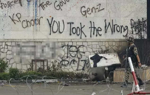 Nepal stares at political void: No clarity on interim leader, ex-chief justice top candidate - What's next after Gen Z protests A Nepal Army personnel keeps vigil outside the vandalized Federal Parliament, a day after it was set ablaze by agitators during anti-government protests, in Kathmandu, Nepal. (PTI Photo)