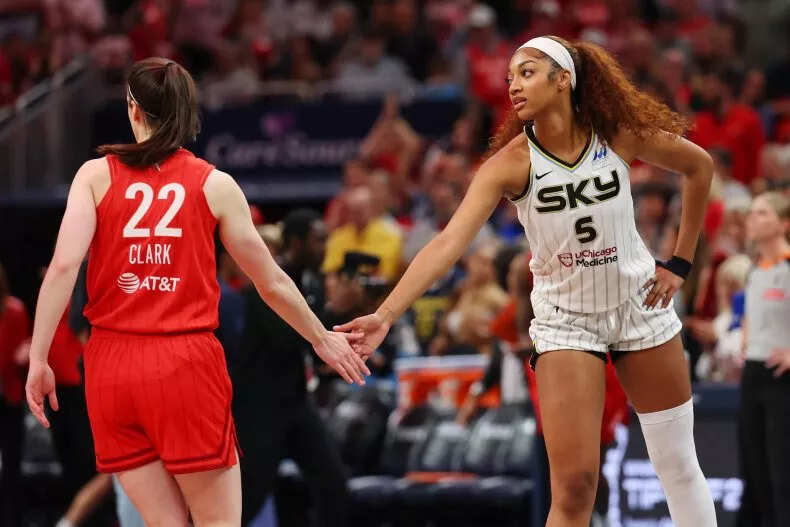 Angel Reese #5 of the Chicago Sky and Caitlin Clark #22 of the Indiana Fever meet at mid court prior to tipoff for the Fever's home opener at Gainbridge Fieldhouse on May 17, 2025 in Indianapolis, Indiana