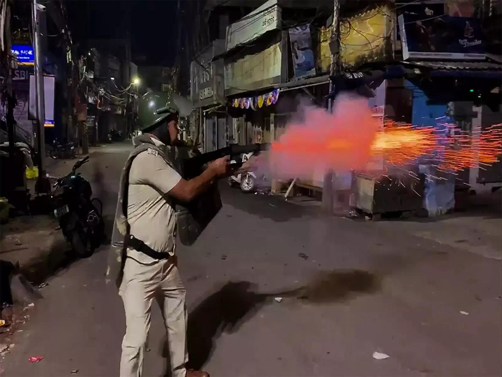 A cop controlling the mob to restore peace in the city. (ANI photo) Internet, social media services suspended in Cuttack for 24 hours.