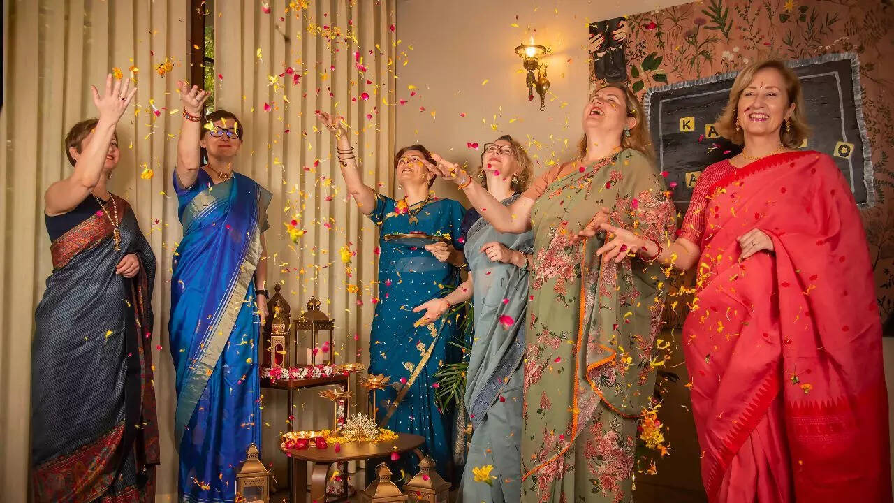 The all-women crew of the Lithuanian Embassy, draped in vibrant saris, rejoicing the spirit of Diwali with grace