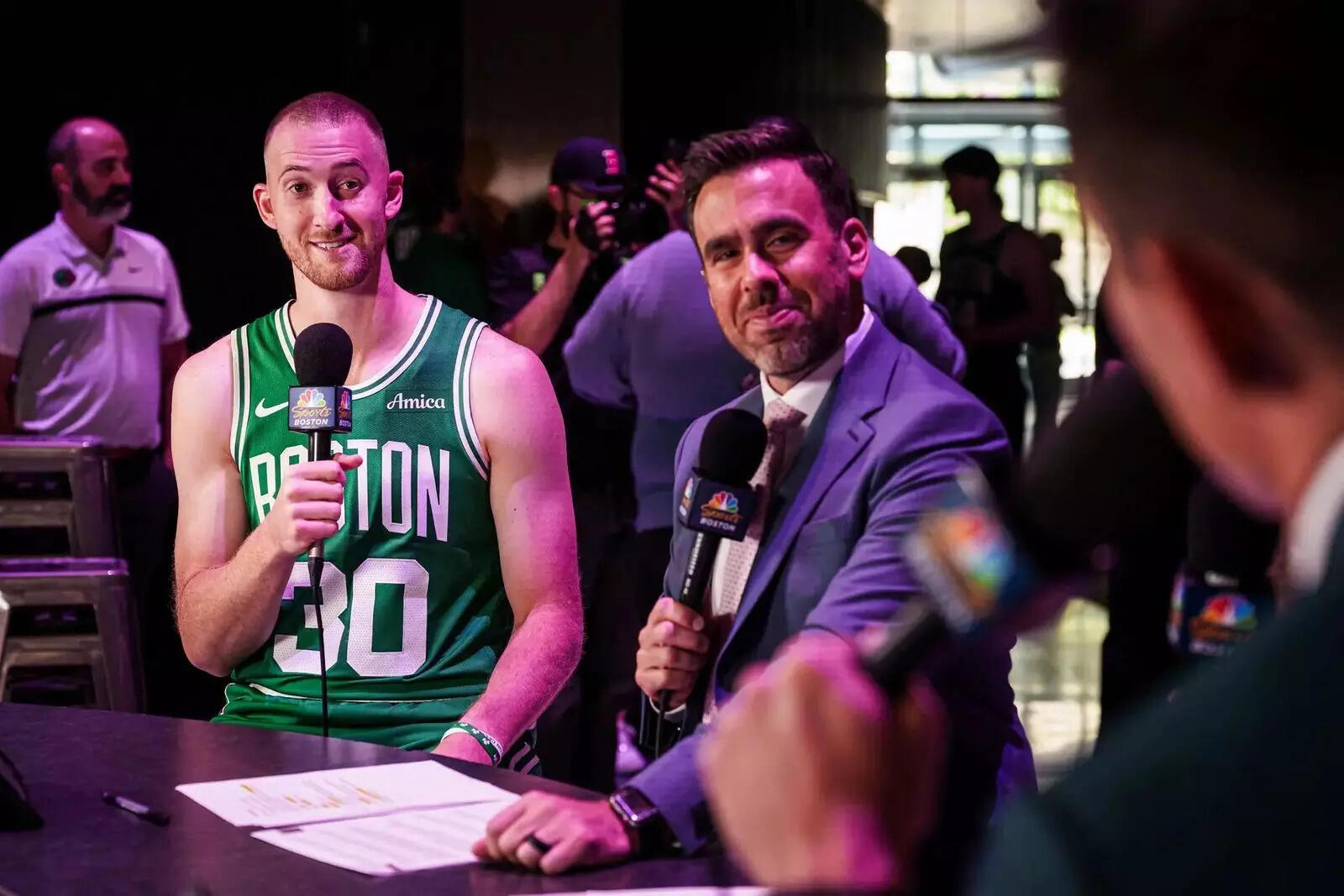 Boston Celtics forward Sam Hauser (30) talks with on air personalities during media day at the Auerbach Center
