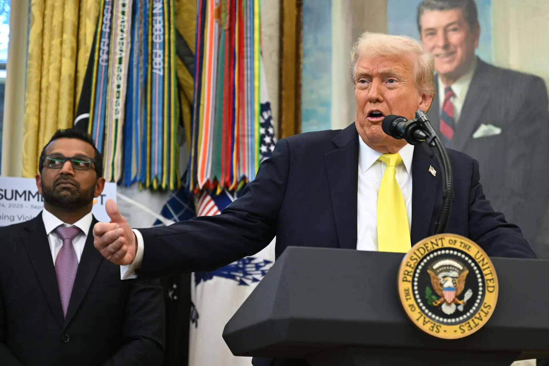 President Donald Trump speaks during an event in the Oval Office at the White House, Wednesday, Oct. 15, 2025, in Washington, as FBI director Kash Patel listens. (AP Photo/John McDonnell) Trump