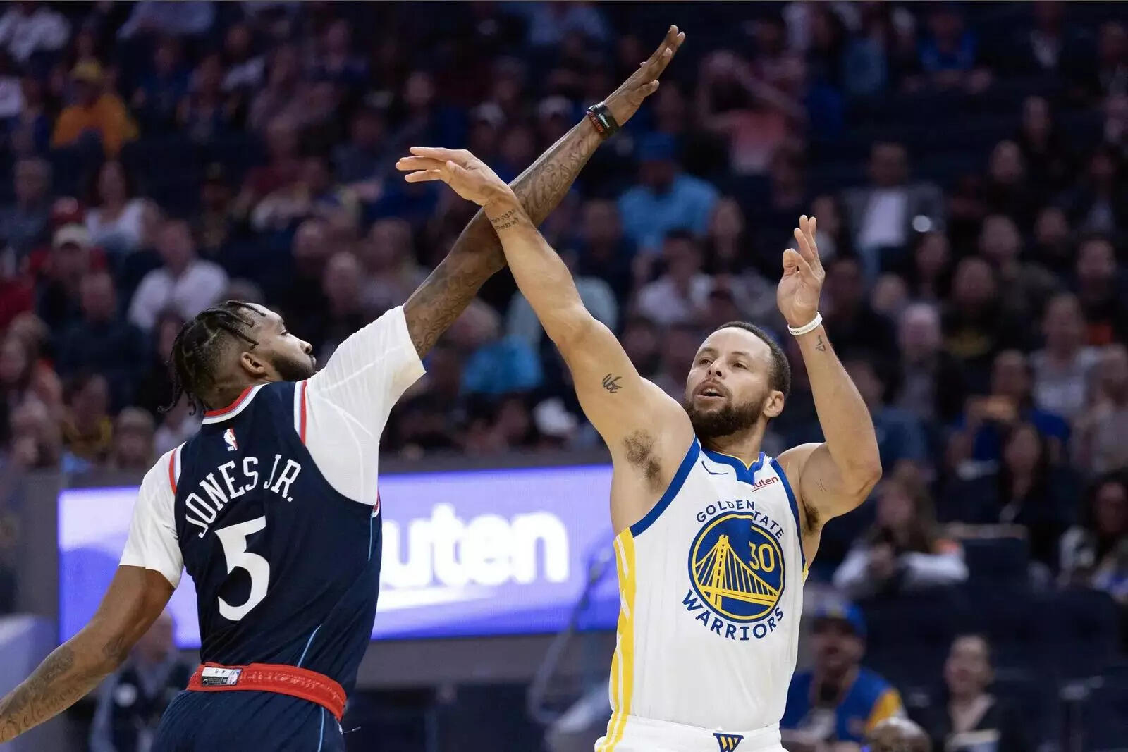 Golden State Warriors guard Stephen Curry (30) is fouled by Los Angeles Clippers forward Derrick Jones Jr. (5) as he shoots
