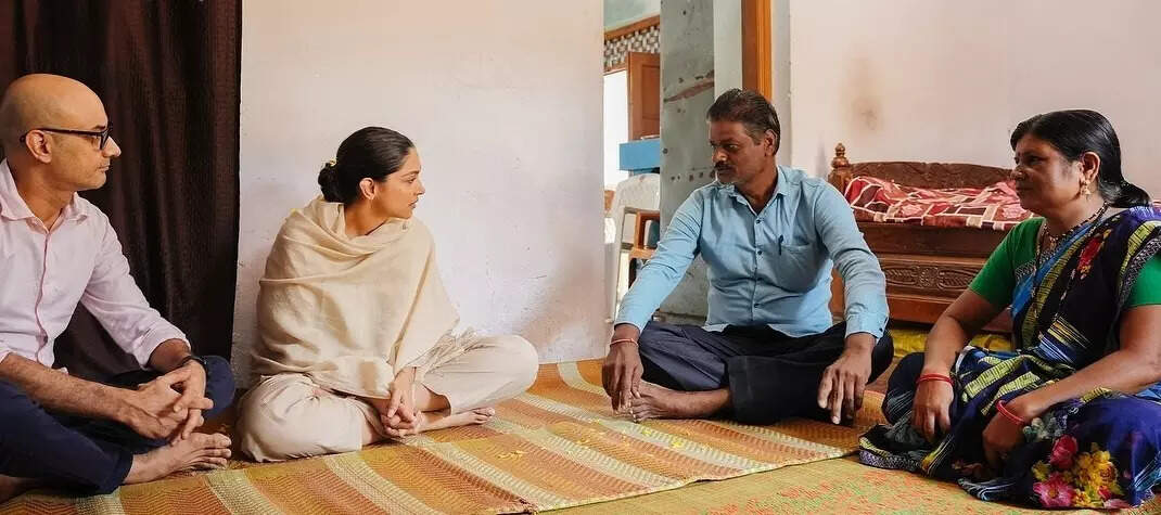 Deepika Padukone and Dr Shyam Bhat in conversation with beneficiary Dharamdas, who now chairs a local carer group in the district