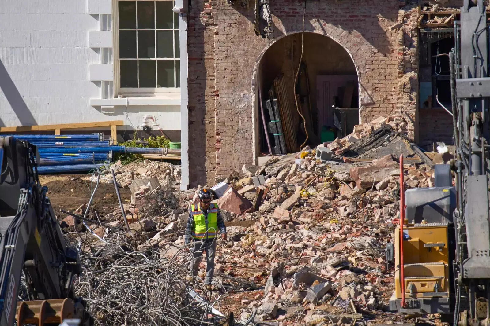 A worker walks through debris at a largely demolished part of the East Wing of the White House (AP Image)