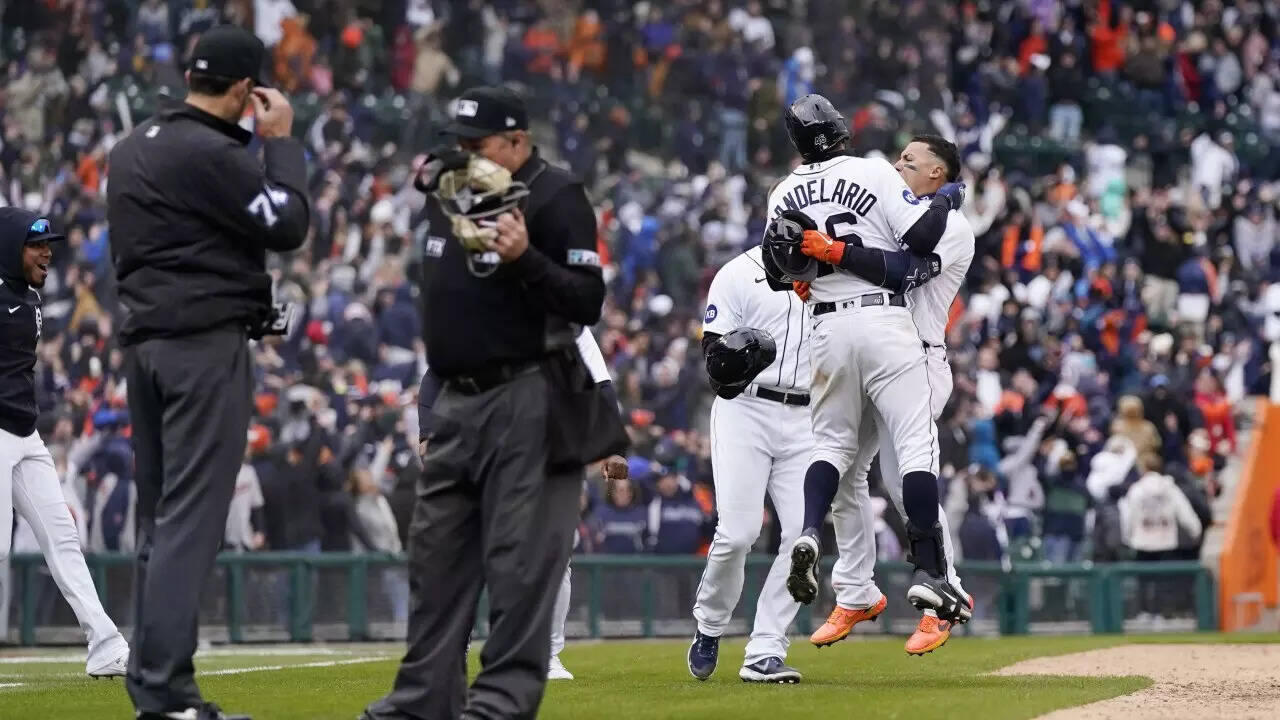 Detroit Tigers greet Javier Baez, right, after hitting a walk-off single