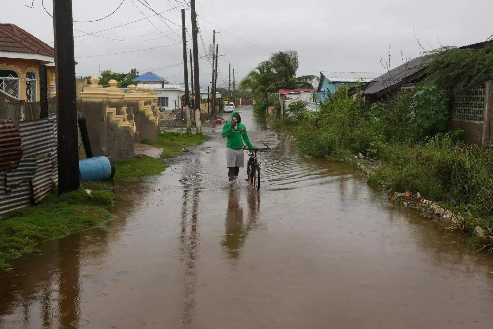 A man wades through a flooded street ahead of the forecasted arrival of Hurricane Melissa in Old Harbour, Jamaica (AP image)  A man wades through a flooded street ahead of the forecasted arrival of Hurricane Melissa in Old Harbour, Jamaica (AP image)