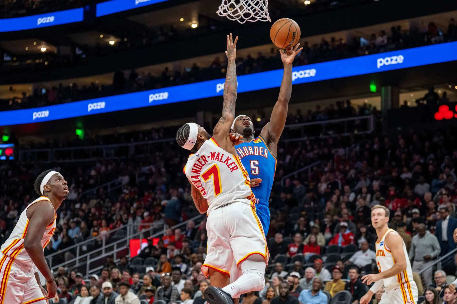 Oklahoma City Thunder guard Luguentz Dort (5), right, attempts a basket against Atlanta Hawks guard Nickeil Alexander-Walker (7) during the first half of an NBA basketball game, Saturday, Oct. 25, 2025, in Atlanta. (AP Photo/Erik Rank) Holmgren scores 31 points, Gilgeous-Alexander has 30 to lead Oklahoma City past the Hawks 117-100
