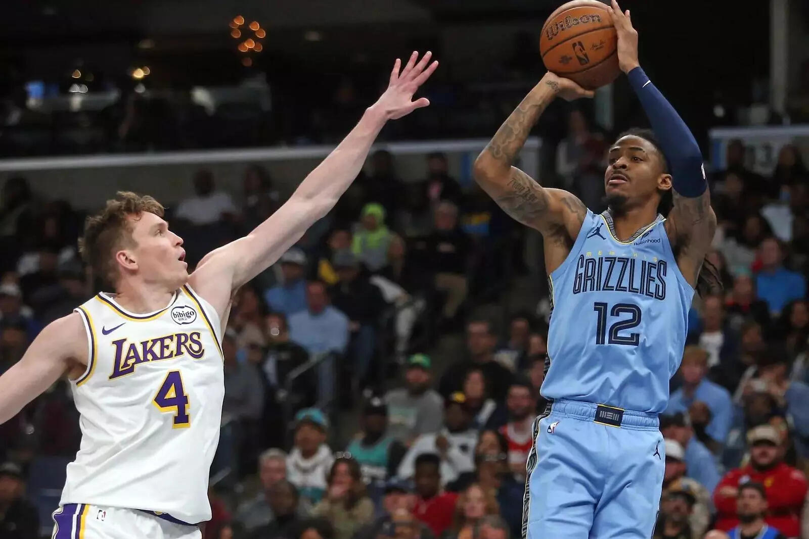 Memphis Grizzlies guard Ja Morant (12) shoots for three as Los Angeles Lakers forward Dalton Knecht (4)