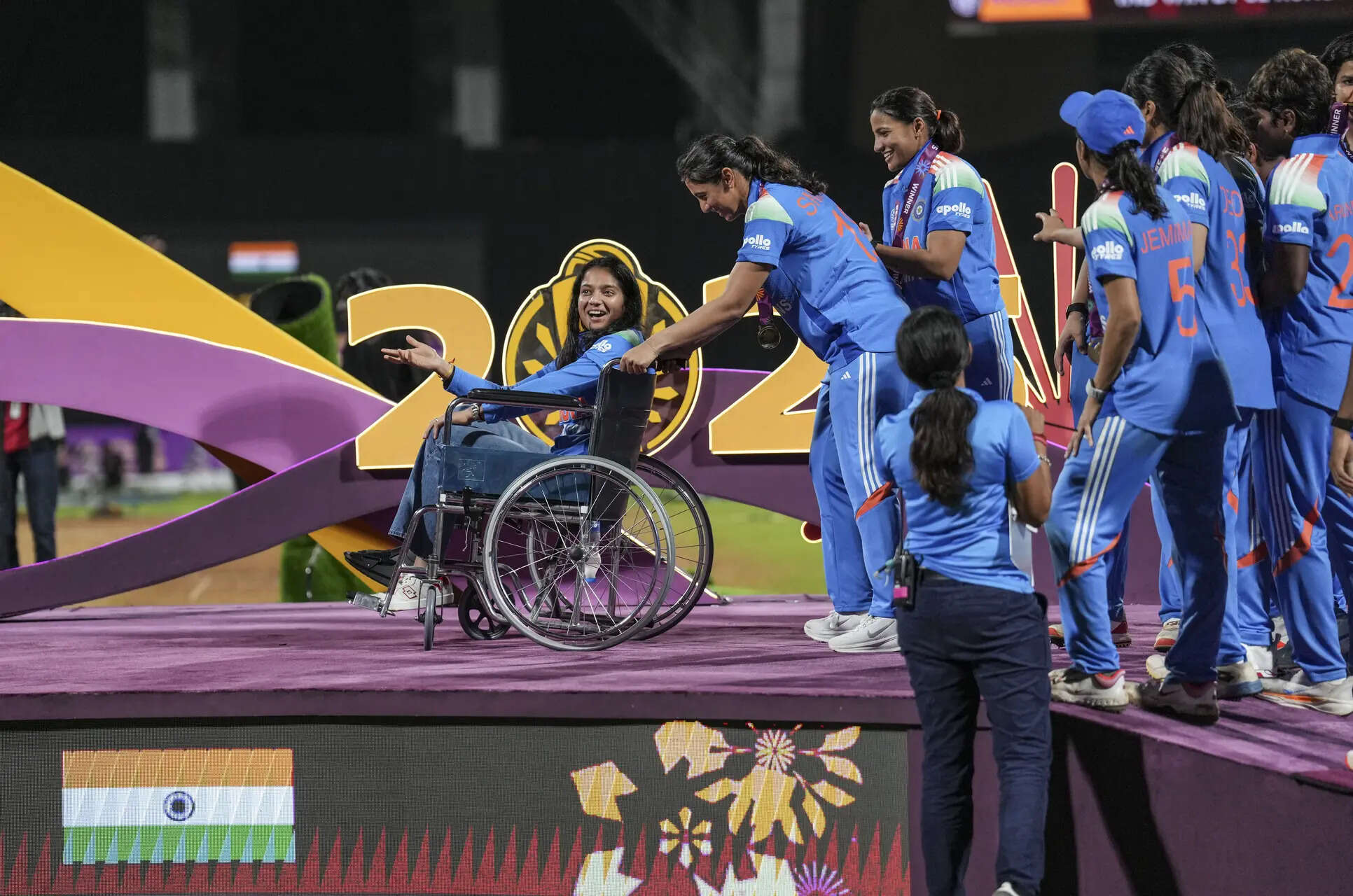 Navi Mumbai: India's Smriti Mandhana brings teammate Pratika Rawal on a wheelchair as the team arrive to receive winning medals during the presentation ceremony after winning the ICC Women's World Cup 2025, at the DY Patil Stadium, in Navi Mumbai, early Monday, Nov. 3, 2025. (PTI Photo/Kunal Patil) (PTI11_03_2025_000077B) ICC Women's WC Final: IND-W vs SA-W