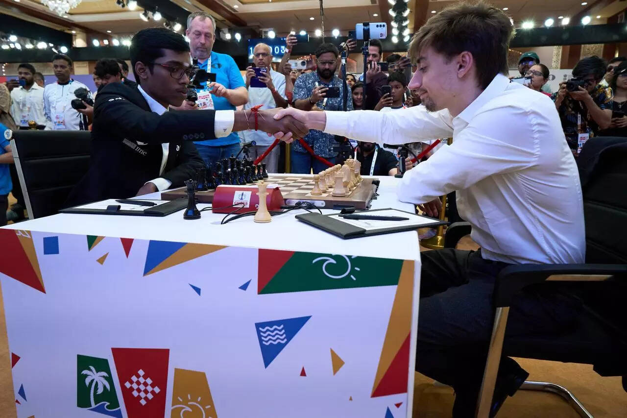 Eteri Kublashvili/FIDE.) Praggnanandaa greets his opponent before the start of his ROUND 4 Game 2 ma