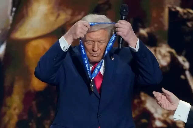 Trump puts on his FIFA Peace Prize during the draw for the 2026 soccer World Cup